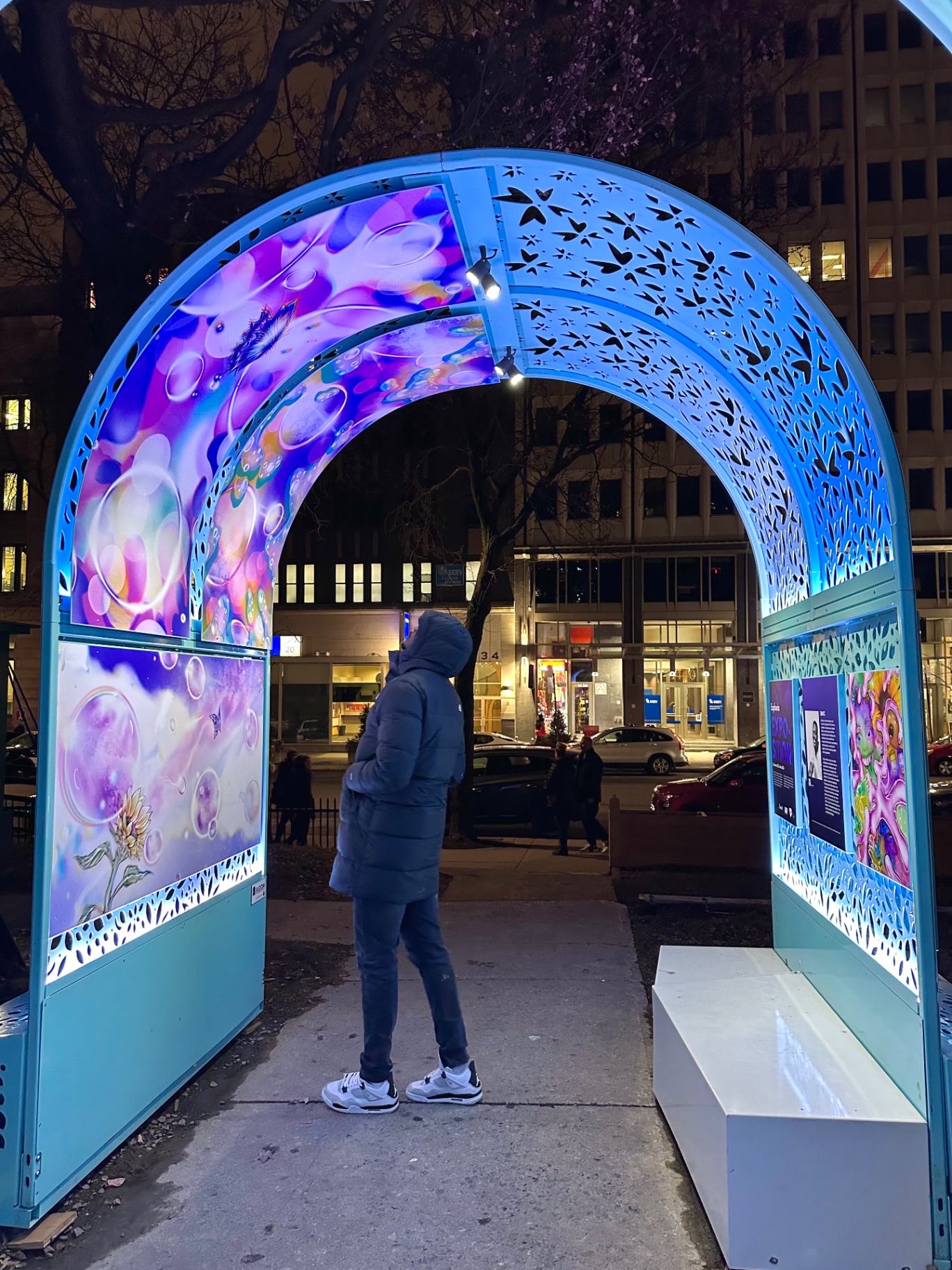 Downtown arche at night, viewer in silhouette